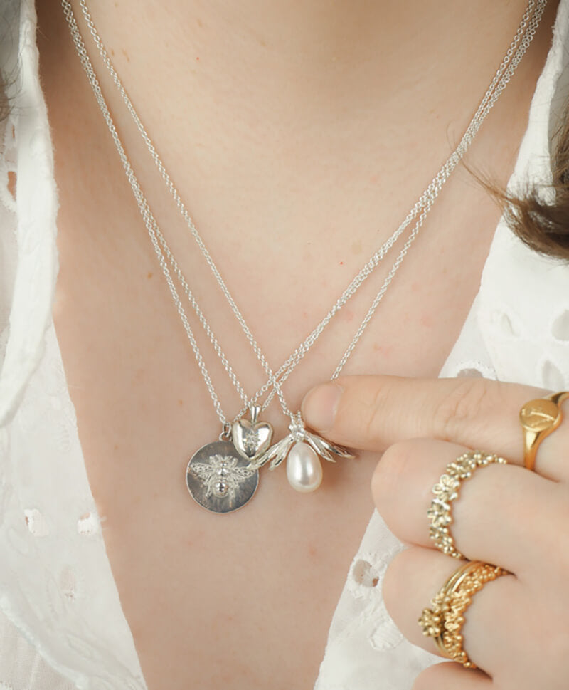 silver pearl bee necklace on model