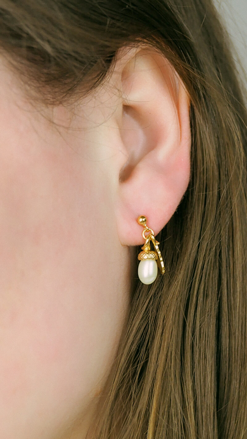 pearl acorn earrings on model