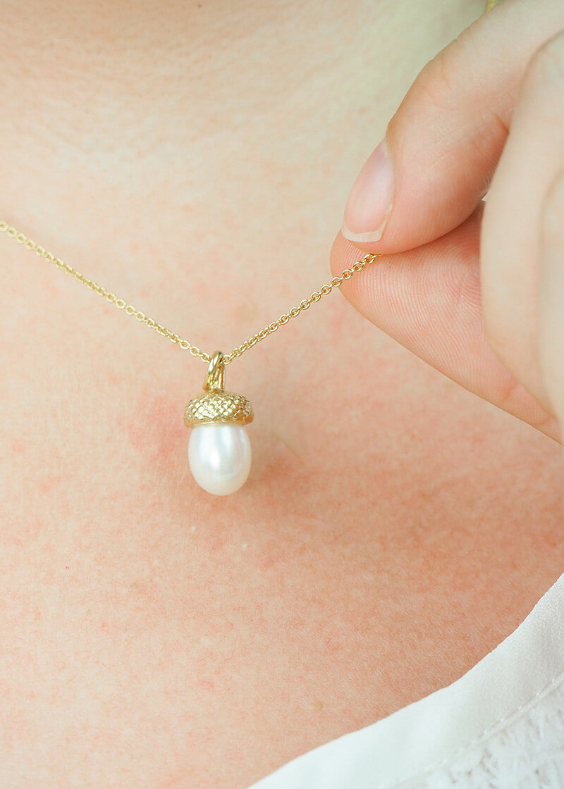 yellow gold pearl acorn necklace on model