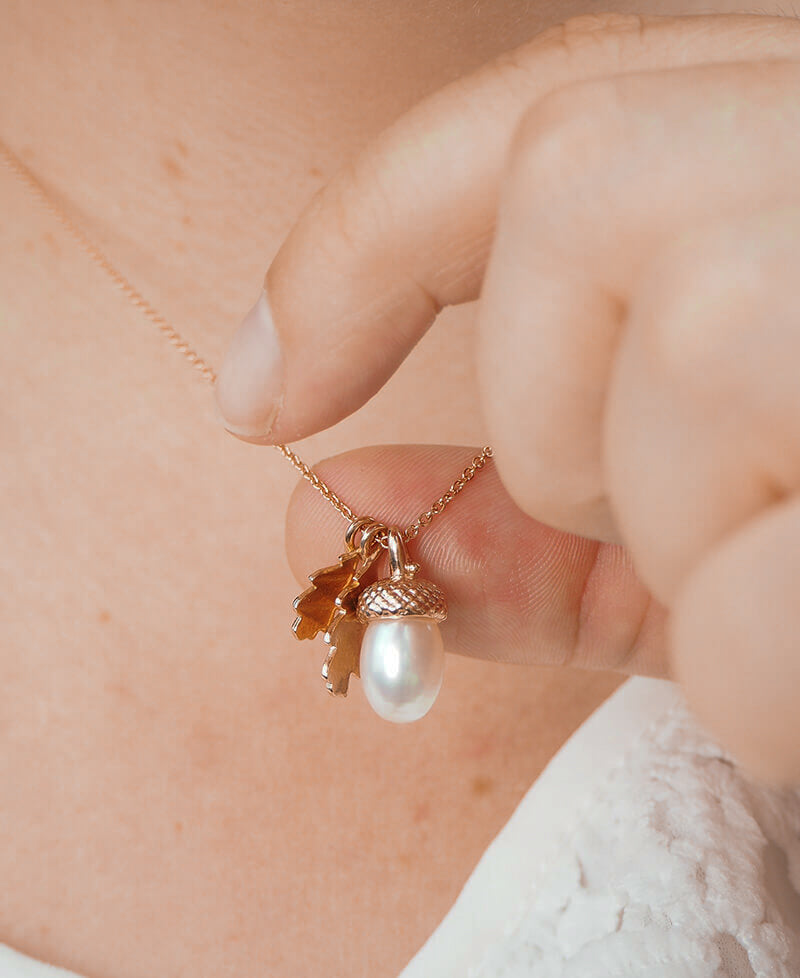 rose gold pearl acorn necklace on a model