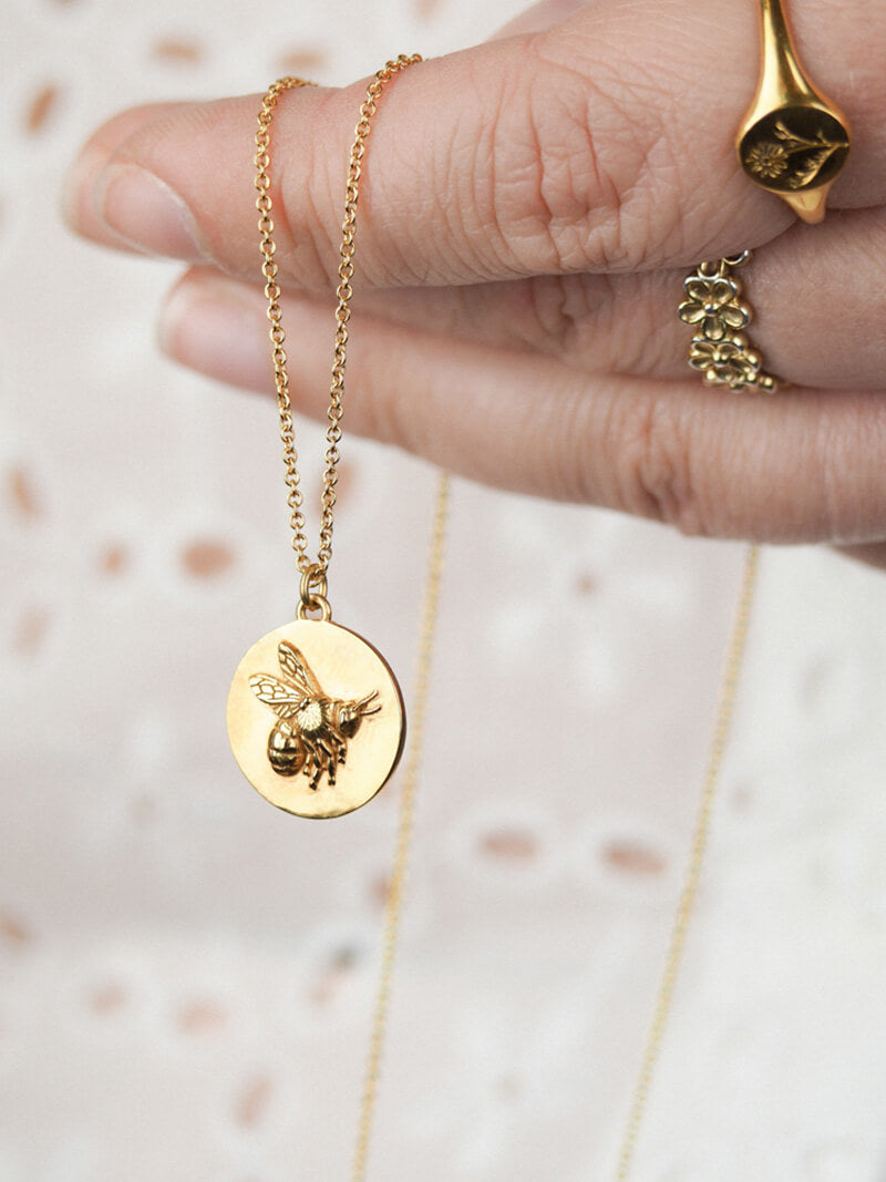 gold flying bee coin pendant in gold