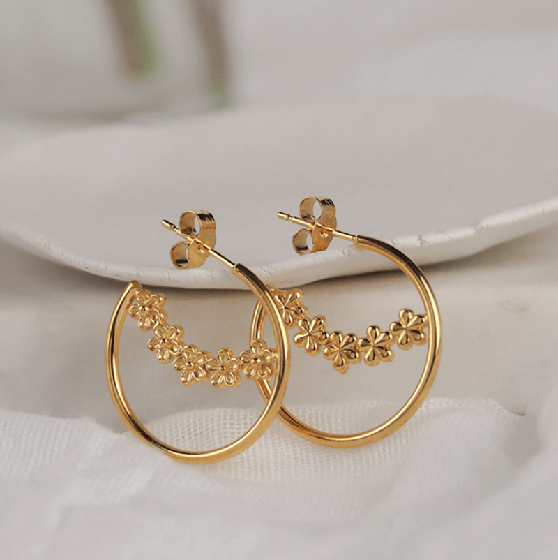 gold hoop earrings with small flowers