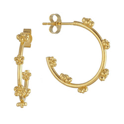 yellow gold hoop earrings with small flowers dotted along hoop