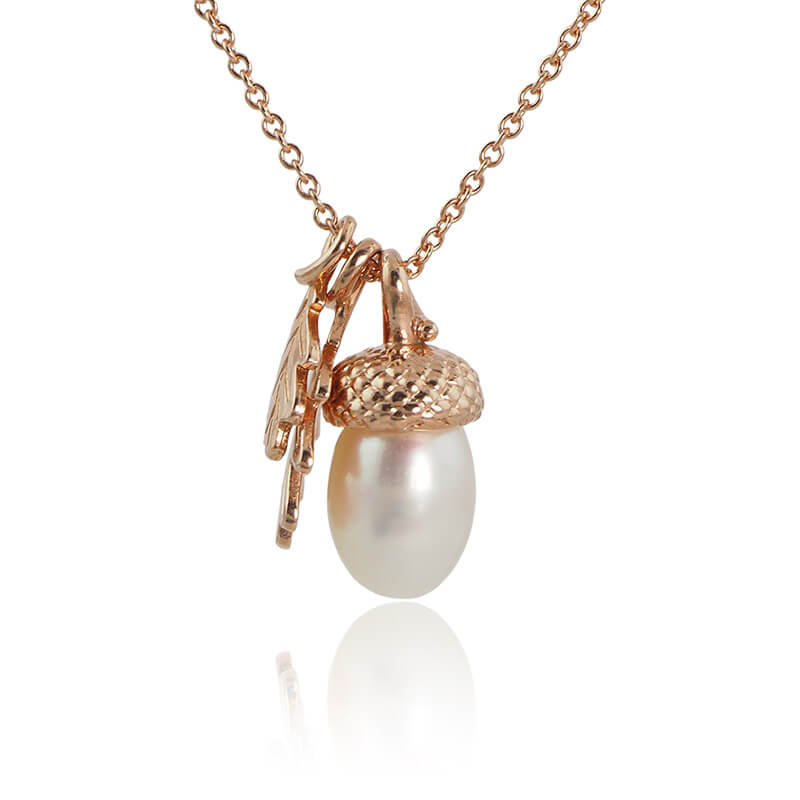 rose gold pearl acorn necklace on a white background
