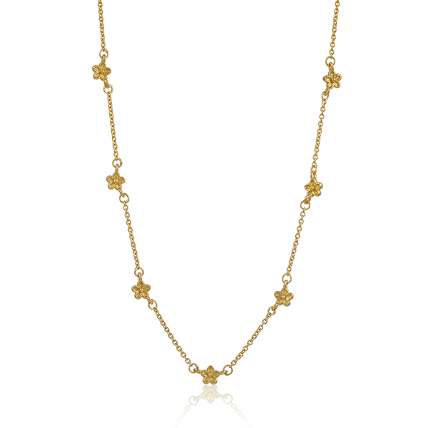 yellow gold delicate necklace with tiny flowers dotted along chain
